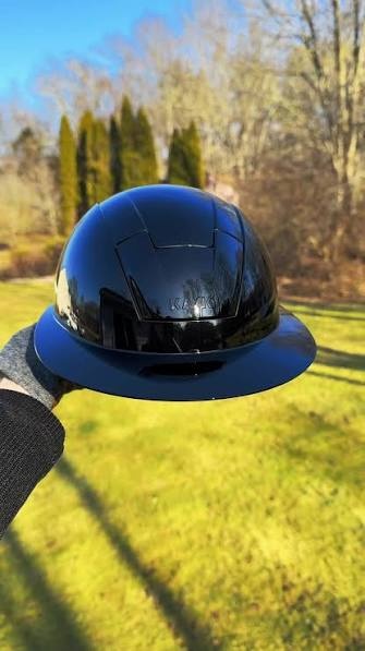 KASK Kooki Lady riding helmet, navy shine, held in hand